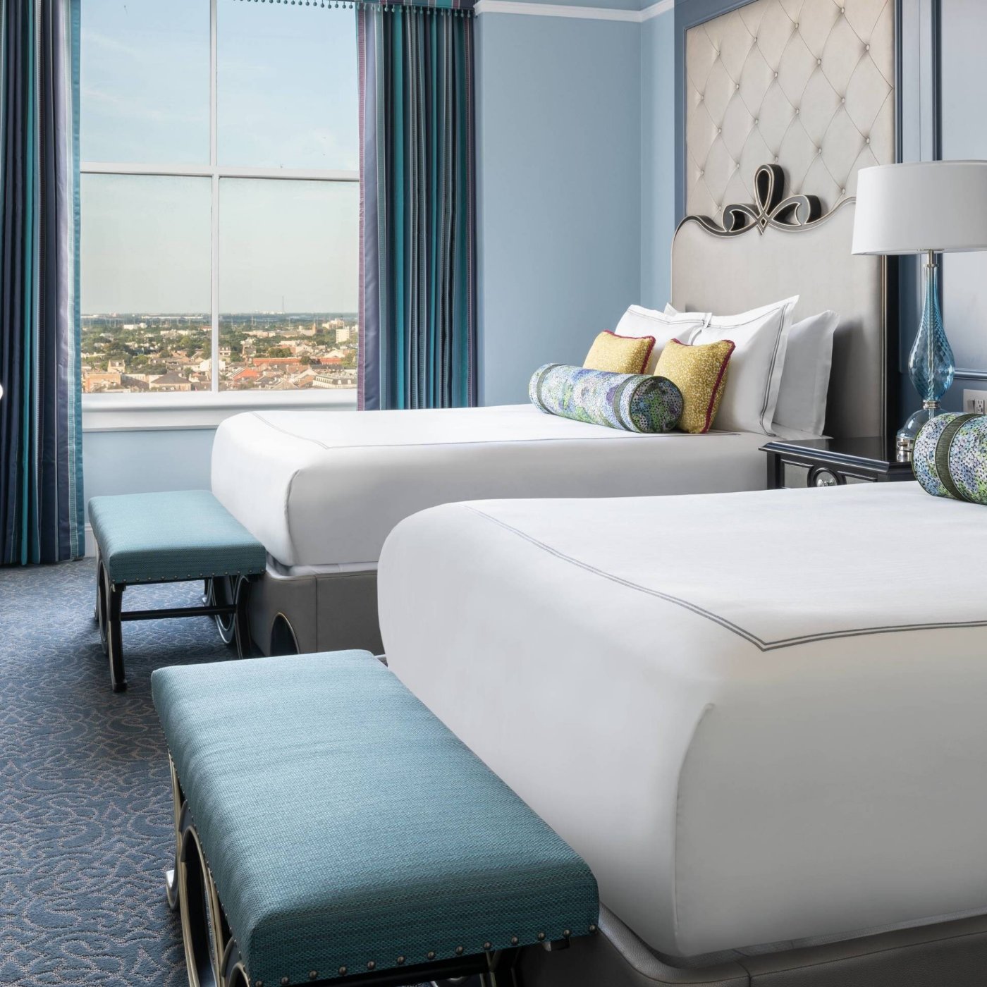 Guest room at The Ritz-Carlton, New Orleans, with two beds and a view of the city