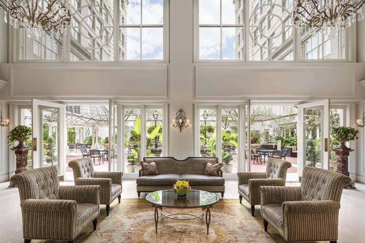Light-filled lobby lounge at The Ritz-Carlton, New Orleans, opening onto the courtyard